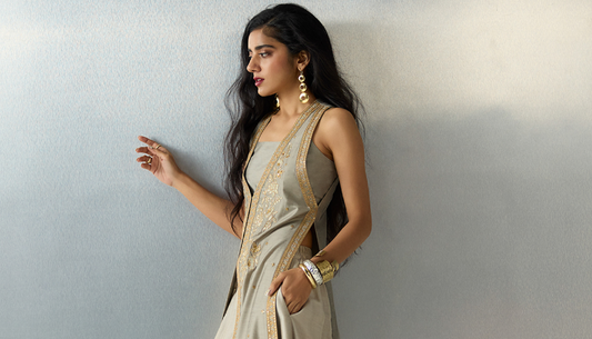 Woman in festive cocktail outfit posing in elegant wedding-style attire