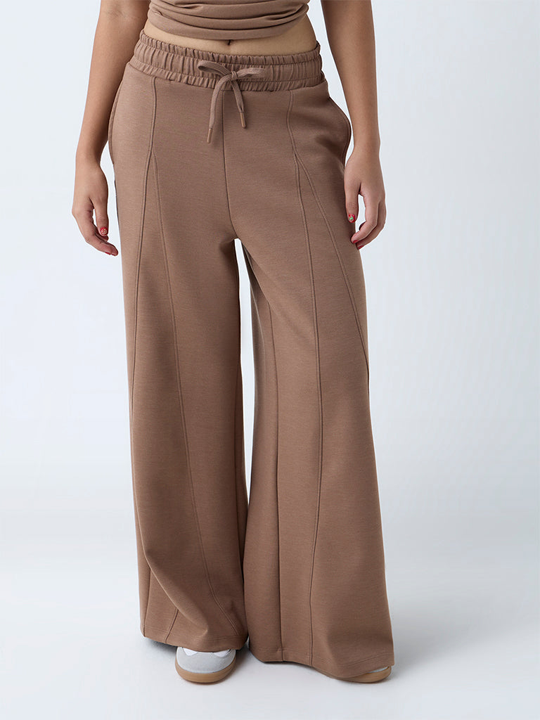 Westside Studiofit Women's Brown Solid High-Rise Track Pants for Sports Wear Front View