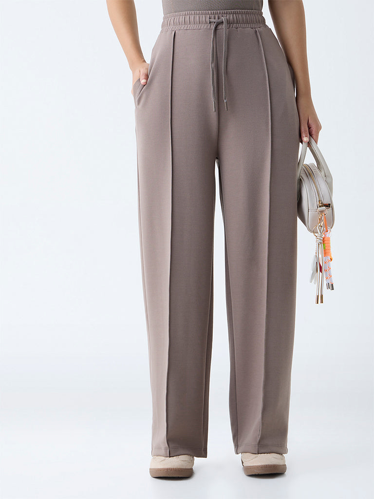 Westside Studiofit Women's Brown Solid High-Rise Track Pants for Sports Wear Front view
